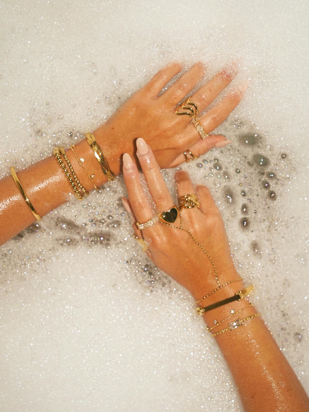 Layered gold and silver jewelry worn together